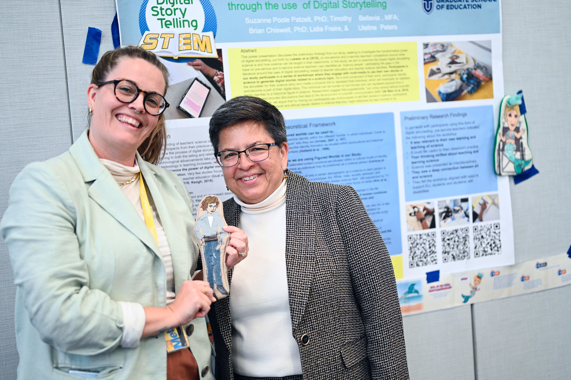 Student smiling with dean in front of research poster